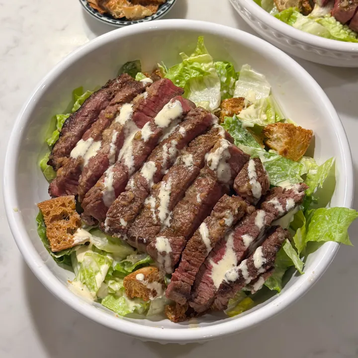 Joseph's Steakhouse signature dishes Bone-In Rib Eye Steak, Porterhouse Steak, Filet Mignon, Caesar Salad